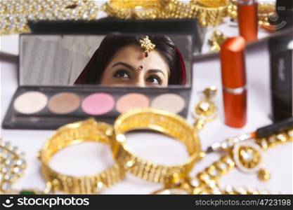 Reflection of brides eyes in makeup mirror