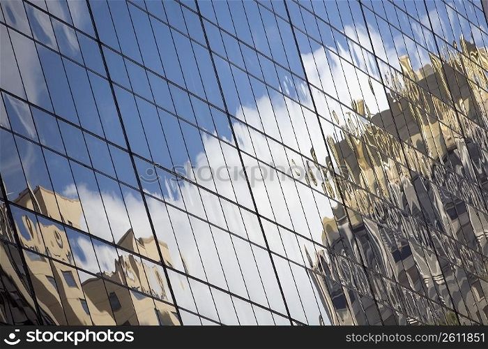 Reflection of buildings on the window glasses of an office building
