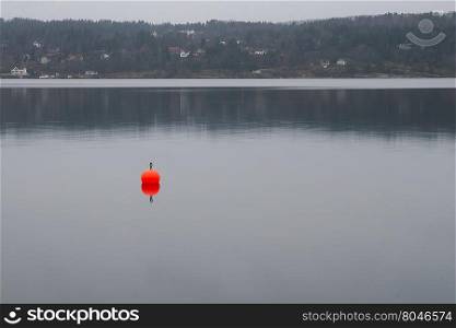 Reflection of buoy along the shores of the bay of Oslo