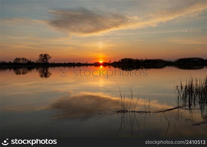Reflection of cloud in a calm lake at sunset, Stankow, Lubelskie, Poland