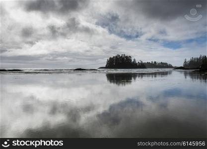 Reflection of clouds in water on beach, Pacific Rim National Park Reserve, British Columbia, Canada
