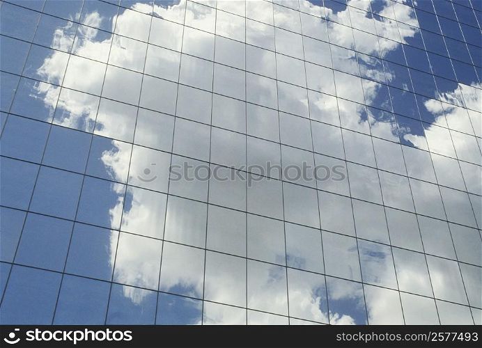 Reflection of clouds on the glass front of a building