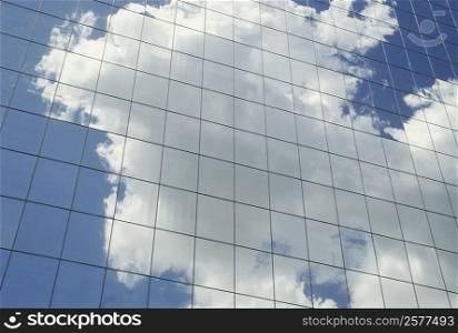 Reflection of clouds on the glass front of a building