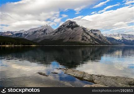 Reflection of Fairholme Range in Minnewanka Lake, Banff National Park in Alberta, Canada