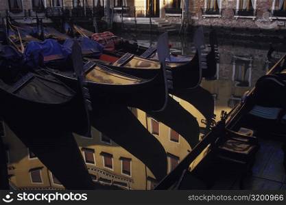 Reflection of gondolas and a building in water, Italy