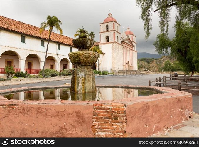 Reflection of Mission Santa Barbara in California exterior on stormy day with clouds
