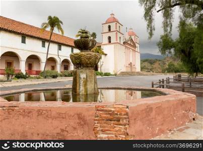 Reflection of Mission Santa Barbara in California exterior on stormy day with clouds