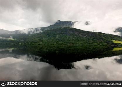 Reflection of mountain with clouds in the lake, Granvinsvatnet, Granvin, Hordaland County, Norway