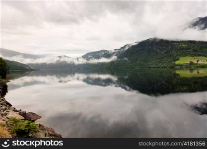 Reflection of mountains with clouds in the lake, Granvinsvatnet, Granvin, Hordaland County, Norway
