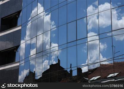 Reflection of old hauses and sky in the modern glass huose in Belgrade,Serbia