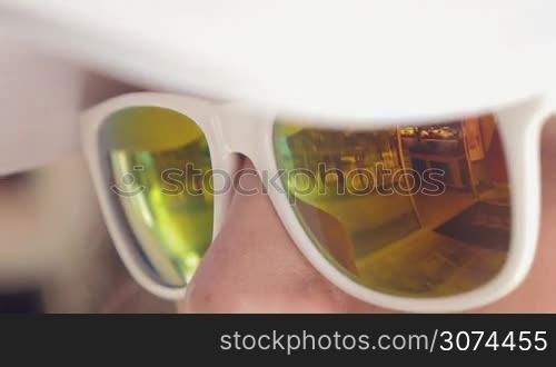 Reflection of shop entrance in mirrored sunglasses