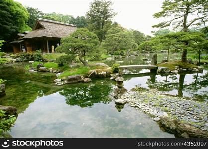 Reflection of trees and rocks in a lake, Katsura Imperial Garden, Katsura Imperial Villa, Kyoto, Japan