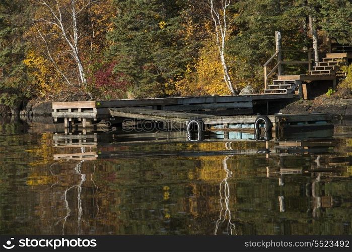 Reflection of trees in water, Kenora, Lake of The Woods, Ontario, Canada