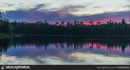 Reflection of trees on water, Lake of The Woods, Ontario, Canada