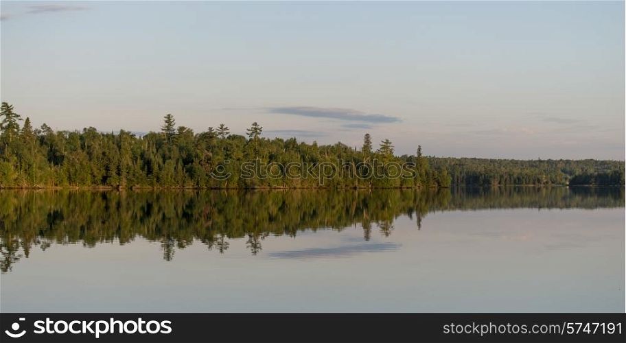Reflection of trees on water, Lake of The Woods, Ontario, Canada