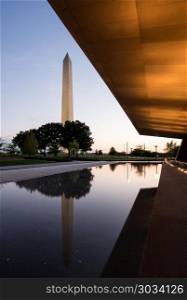 Reflection of Washington in reflecting pool at sunset. WASHINGTON DC, USA - JULY 8: National Museum of African American History and Culture in Washington DC on July 8, 2017. The museum opened on September 24, 2016.. Reflection of Washington in reflecting pool at sunset