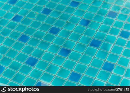 reflection on the blue clear water ripples of swimming pool with mosaic bottom. water ripples of swimming pool