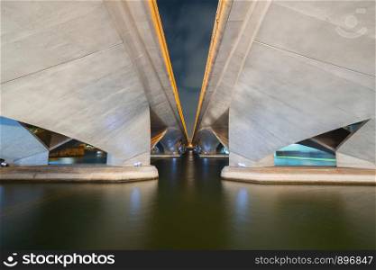 Reflection under Esplanade Bridge in structure of architecture concept, urban city, Singapore Downtown area at night.