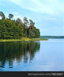 Reflections on a summer wilderness lake and nice pine forest on coast