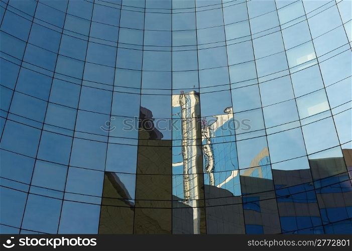 Reflections the Urban Construction on the Facade of a Modern Office Building