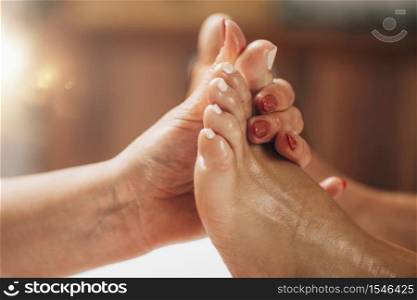 Reflexology Foot Massage. Reflexologist applying pressure to client&rsquo;s big toe at a wellness center. Reflexology Foot Massage. Reflexologist Applying Pressure to client&rsquo;s Big Toe