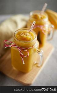 Refreshing and healthy mango smoothie in glasses.