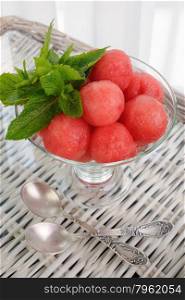 Refreshing appetizer of watermelon balls with mint leaves in a glass
