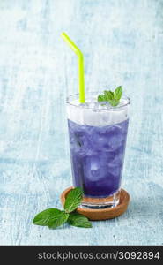 refreshing blue coconut cocktail on blue stone background