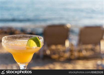 Refreshing Classic Margarita Cocktail With Lime And Salt By The Beach At Sunset On Blurred Background