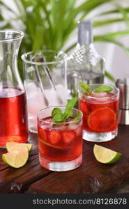 Refreshing cocktail strawberry mojito with ice, fresh mint and lime. A great idea for a picnic or summer party. It may contain alcohol or be a mocktail.