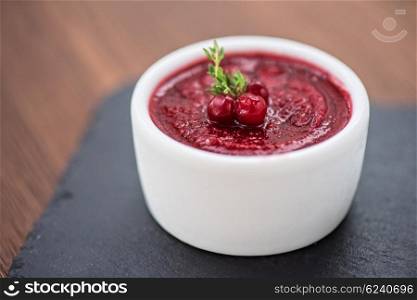 Refreshing cranberry sorbet. Refreshing cranberry sorbet at white bowl