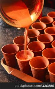 Refreshing cutting Chai or tea in mud cups. Refreshing cutting Chai or tea in mud cups.