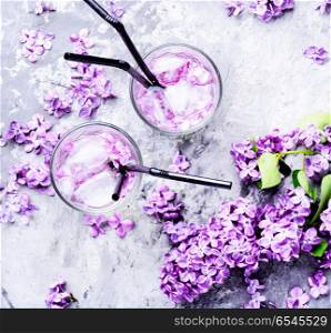 Refreshing drink with lilac and ice. Refreshing summer cocktail with lilac flowers.Detox drink