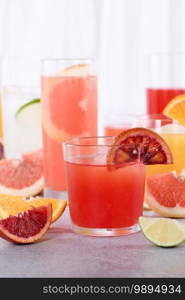 Refreshing freshly squeezed Sicilian orange juice among fresh detox citrus juices from  orange, grapefruit, lime
