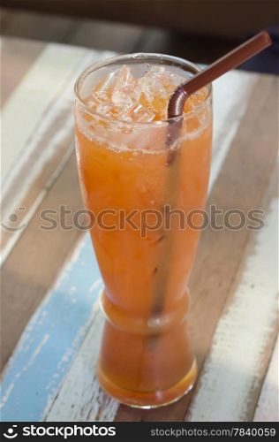 Refreshing glass of iced tea on table