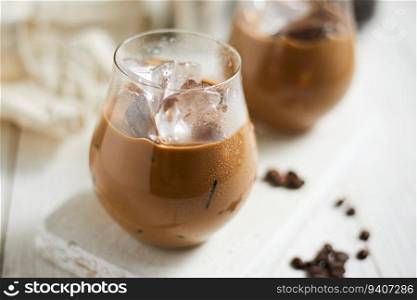 Refreshing iced latte coffee in a glass , selective focus 
. Refreshing iced latte coffee in a glass