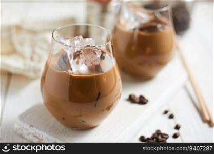 Refreshing iced latte coffee in a glass , selective focus 
. Refreshing iced latte coffee in a glass