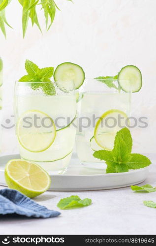 Refreshing infused water with cucumber, mint and lime. Summer drink cocktail lemonade. Healthy drink and detox concept