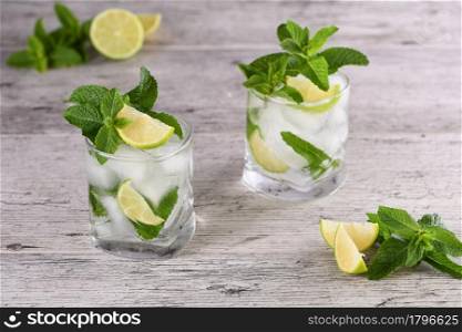 Refreshing summer alcoholic cocktail mojito with ice, fresh mint and lime