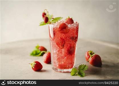 Refreshing summer drink with strawberry slices and fresh berries on light background. Strawberry cocktail in a glass. Strawberry cocktail in a glass
