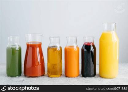 Refreshing summer drinks. Orange, carrot, apple, tomato, spinach and pomegranate juice in glass jars isolated over white background