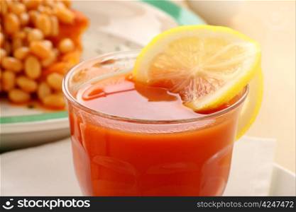 Refreshing tomato juice and lemon with baked beans for breakfast.