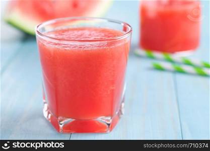 Refreshing watermelon juice on blue wood (Selective Focus, Focus on the front of the glass rim). Fresh Watermelon Juice