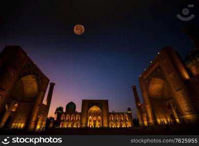 Registan Square in Samarkand. Madrasah at night with light