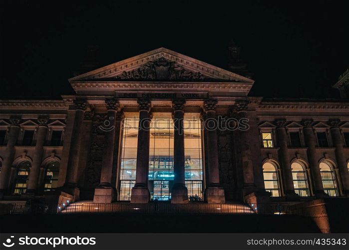 Reichstag in Berlin, Germany at night, illuminated with warm light
