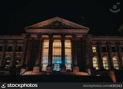 Reichstag in Berlin, Germany at night, illuminated with warm light