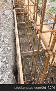 Reinforcement of the strip foundation with metal reinforcement in a trench with formwork