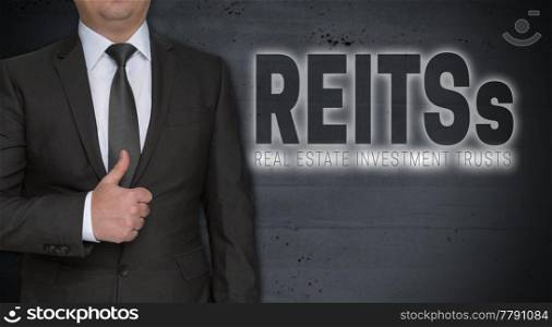 Reits concept and businessman with thumbs up.. Reits concept and businessman with thumbs up