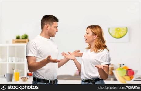 relationship difficulties, conflict and emotions concept - unhappy couple having argument over home kitchen background. unhappy couple having argument at kitchen