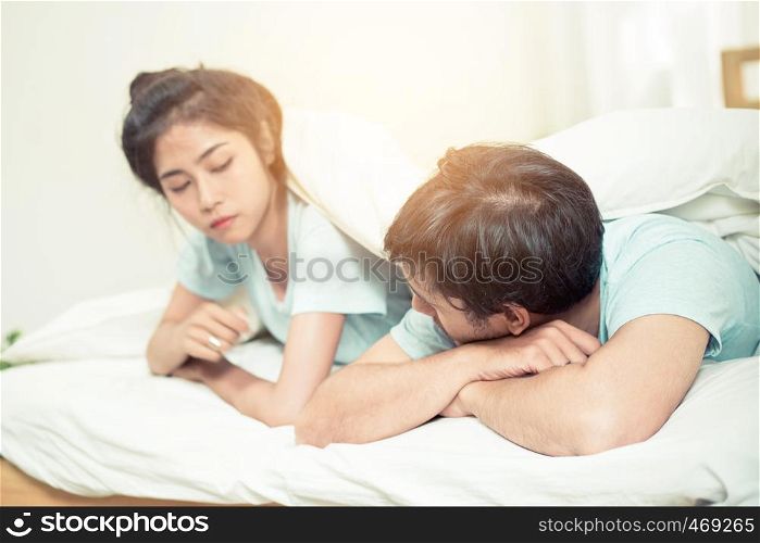 Relationship difficulties, conflict and family concept - unhappy couple having problems at bed - lover with conflict and stress on bedroom.